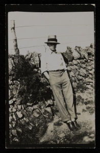 Photograph of Ben Nicholson in a hat leaning against a wall